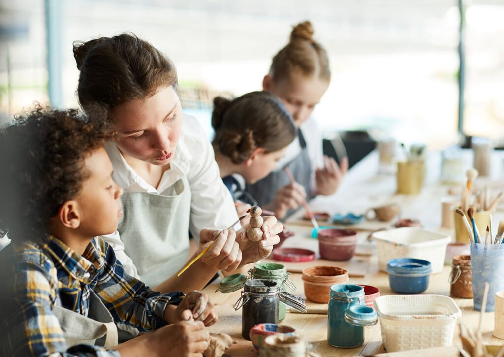 group of 4 people pottery painting